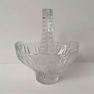 Small crystal basket with leaf/petal design. Seven inches base to top of handle